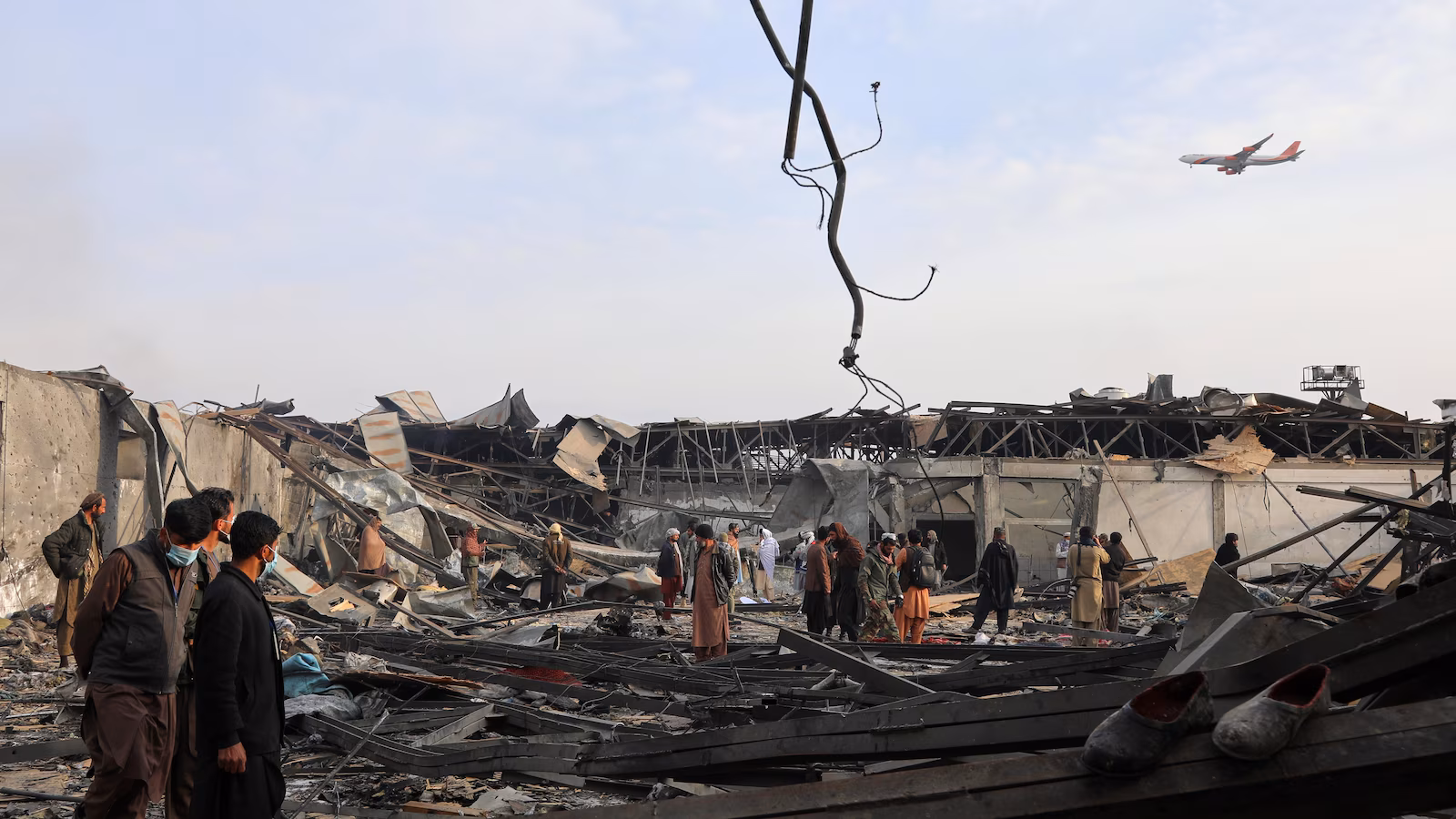 Rescue workers extricate bodies from an airstrike on a Kabul hospital blamed on Pakistan