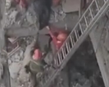 Rescue workers search for debris after an airstrike in Tehran